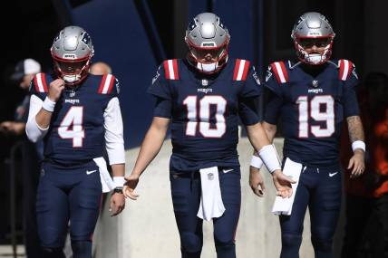 Oct 8, 2023; Foxborough, Massachusetts, USA; New England Patriots quarterback Bailey Zappe (4) quarterback Mac Jones (10) and quarterback Will Grier (19) walk out of the tunnel prior to a game against the New Orleans Saints at Gillette Stadium. Mandatory Credit: Bob DeChiara-USA TODAY Sports