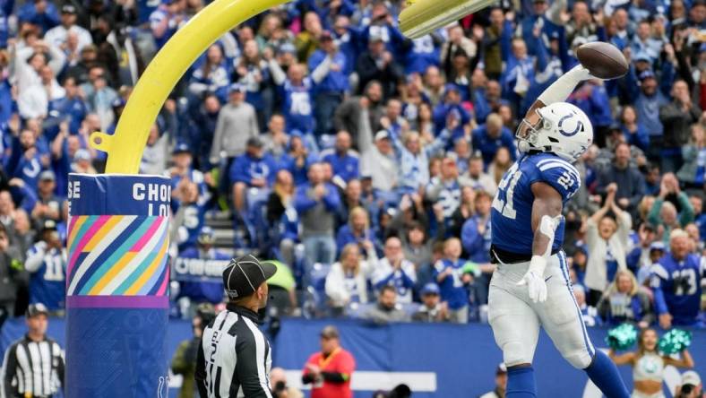 Indianapolis Colts running back Zack Moss (21) dunks the ball over the goal post after scoring a touchdown Sunday, Oct. 8, 2023, during a game against the Tennessee Titans at Lucas Oil Stadium in Indianapolis.