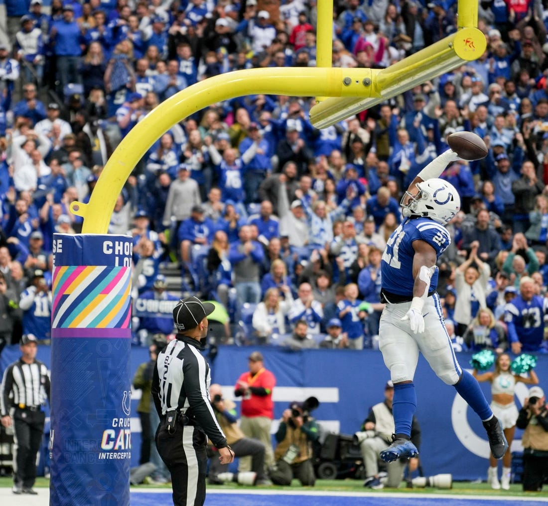 Indianapolis Colts running back Zack Moss (21) dunks the ball over the goal post after scoring a touchdown Sunday, Oct. 8, 2023, during a game against the Tennessee Titans at Lucas Oil Stadium in Indianapolis.