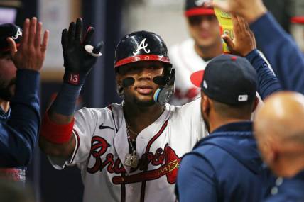 Oct 9, 2023; Cumberland, Georgia, USA; Atlanta Braves right fielder Ronald Acuna Jr. (13) celebrates in the dugout after scoring a run during the sixth inning against the Philadelphia Phillies in game two of the NLDS for the 2023 MLB playoffs at Truist Park. Mandatory Credit: Brett Davis-USA TODAY Sports
