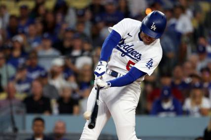 Oct 9, 2023; Los Angeles, California, USA; Los Angeles Dodgers first baseman Freddie Freeman (5) hits a single against the Arizona Diamondbacks in the first inning for game two of the NLDS for the 2023 MLB playoffs at Dodger Stadium. Mandatory Credit: Kiyoshi Mio-USA TODAY Sports