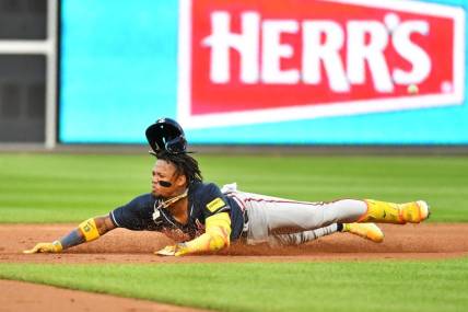 Oct 11, 2023; Philadelphia, Pennsylvania, USA;  Atlanta Braves right fielder Ronald Acuna Jr. (13) slides into second base for a double during the third inning against the Philadelphia Phillies in game three of the NLDS for the 2023 MLB playoffs at Citizens Bank Park. Mandatory Credit: Eric Hartline-USA TODAY Sports