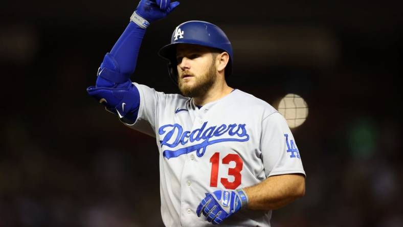 Oct 11, 2023; Phoenix, Arizona, USA; Los Angeles Dodgers third baseman Max Muncy (13) reacts after hitting a single against the Arizona Diamondbacks in the seventh inning for game three of the NLDS for the 2023 MLB playoffs at Chase Field. Mandatory Credit: Mark J. Rebilas-USA TODAY Sports