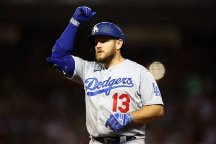 Oct 11, 2023; Phoenix, Arizona, USA; Los Angeles Dodgers third baseman Max Muncy (13) reacts after hitting a single against the Arizona Diamondbacks in the seventh inning for game three of the NLDS for the 2023 MLB playoffs at Chase Field. Mandatory Credit: Mark J. Rebilas-USA TODAY Sports