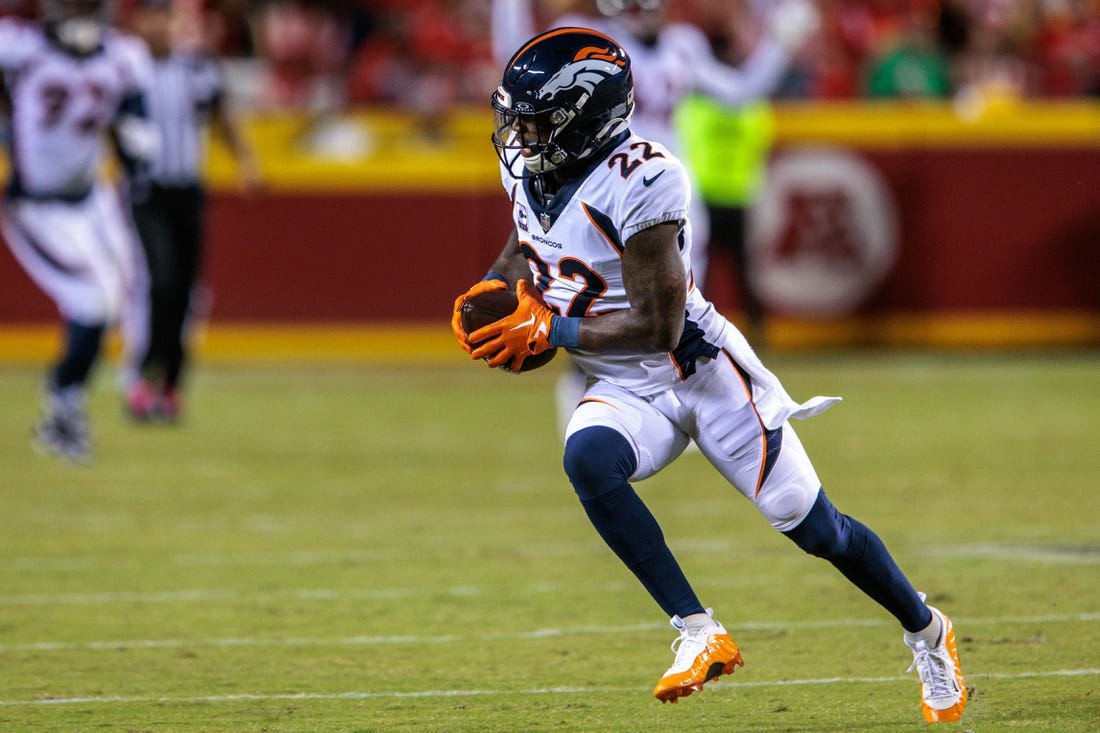 Oct 12, 2023; Kansas City, Missouri, USA; Denver Broncos safety Kareem Jackson (22) runs the ball after an interception during the second quarter against the Kansas City Chiefs at GEHA Field at Arrowhead Stadium. Mandatory Credit: William Purnell-USA TODAY Sports