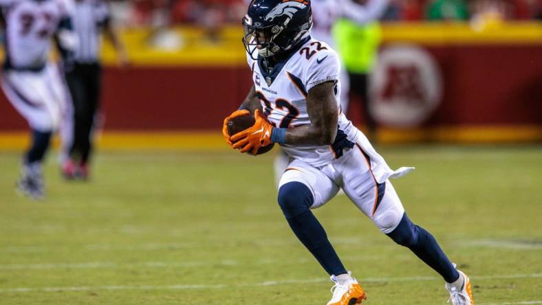 Oct 12, 2023; Kansas City, Missouri, USA; Denver Broncos safety Kareem Jackson (22) runs the ball after an interception during the second quarter against the Kansas City Chiefs at GEHA Field at Arrowhead Stadium. Mandatory Credit: William Purnell-USA TODAY Sports