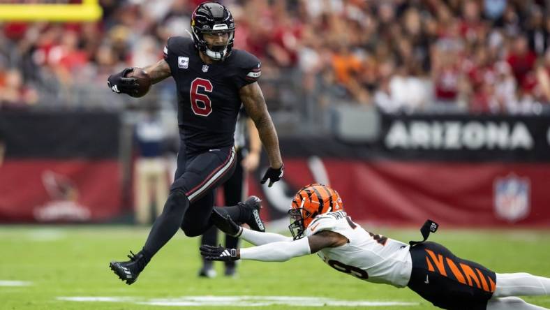 Oct 8, 2023; Glendale, Arizona, USA; Arizona Cardinals running back James Conner (6) against diving Cincinnati Bengals cornerback Cam Taylor-Britt at State Farm Stadium. Mandatory Credit: Mark J. Rebilas-USA TODAY Sports