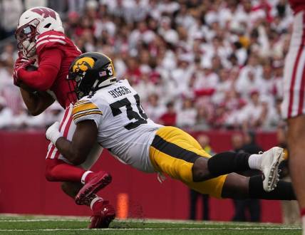 Oct 14, 2023; Madison, Wisconsin, USA; Wisconsin Badgers wide receiver Will Pauling (6) is tackled short of a first down by Iowa Hawkeyes linebacker Jay Higgins (34) during the second quarter at Camp Randall Stadium. Mandatory Credit: Mark Hoffman-USA TODAY Sports