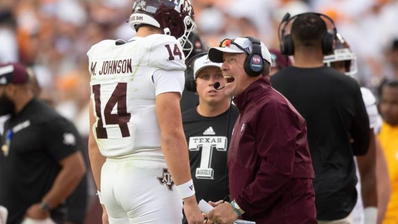 Oct 14, 2023; Knoxville, TN, USA; Texas A&M quarterback Max Johnson (14) talks with Texas A&M head coach Jimbo Fisher during a football game between Tennessee and Texas A&M at Neyland Stadium in Knoxville, Tenn., on Saturday, Oct. 14, 2023. Mandatory Credit: Brianna Paciorka-USA TODAY Sports