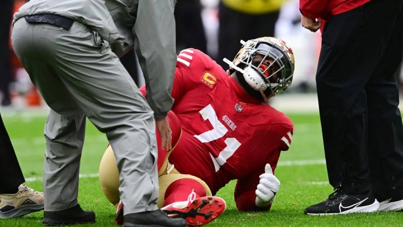 Oct 15, 2023; Cleveland, Ohio, USA; San Francisco 49ers offensive tackle Trent Williams (71) is looked at by trainers during the first half against the Cleveland Browns at Cleveland Browns Stadium. Mandatory Credit: Ken Blaze-USA TODAY Sports