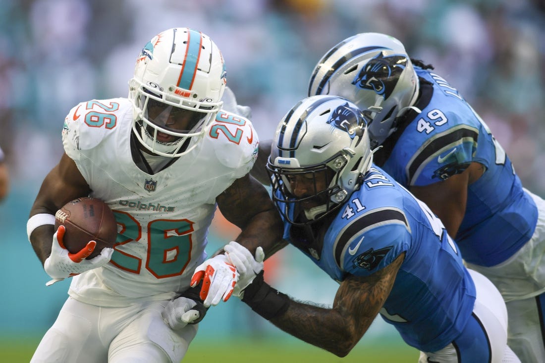 Oct 15, 2023; Miami Gardens, Florida, USA; Miami Dolphins running back De'Von Achane (28) runs with the football against Carolina Panthers safety Matthias Farley (41) during the fourth quarter at Hard Rock Stadium. Mandatory Credit: Sam Navarro-USA TODAY Sports