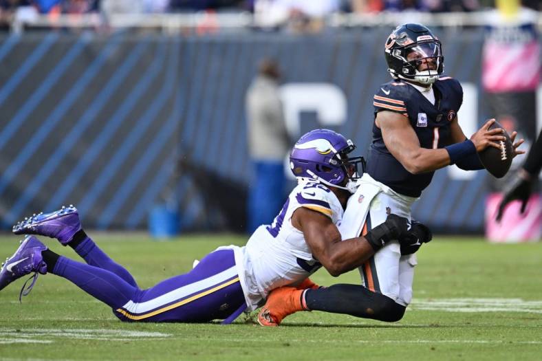 Oct 15, 2023; Chicago, Illinois, USA;  Chicago Bears quarterback Justin Fields (1) is sacked by Minnesota Vikings linebacker Danielle Hunter (99) in the second half at Soldier Field. Mandatory Credit: Jamie Sabau-USA TODAY Sports