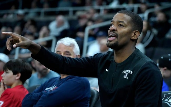 Providence Friars head coach Kim English throws out instructions while watching the Mall Brown scrimmage form the side lines.