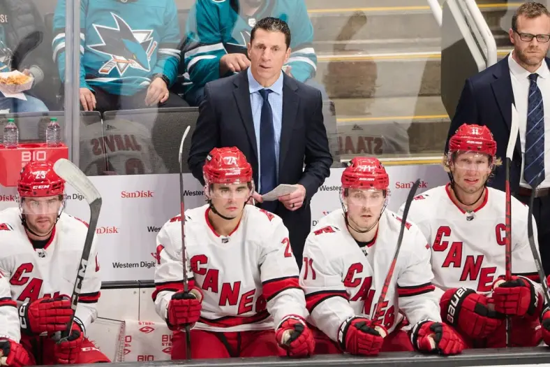 Oct 17, 2023; San Jose, California, USA; Carolina Hurricanes head coach Rod Brind'Amour watches the game from behind the bench against the San Jose Sharks during the third period at SAP Center at San Jose. Mandatory Credit: Robert Edwards-USA TODAY Sports