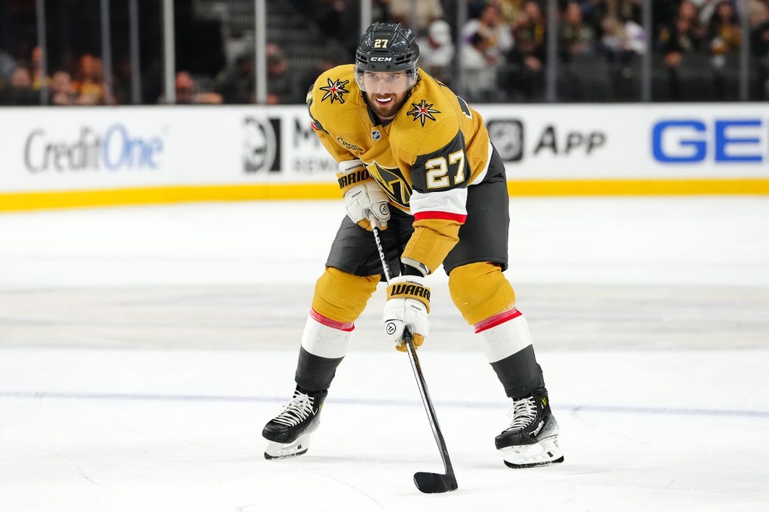 Oct 17, 2023; Las Vegas, Nevada, USA; Vegas Golden Knights defenseman Shea Theodore (27) prepares for a face off against the Dallas Stars during the third period at T-Mobile Arena. Mandatory Credit: Stephen R. Sylvanie-USA TODAY Sports