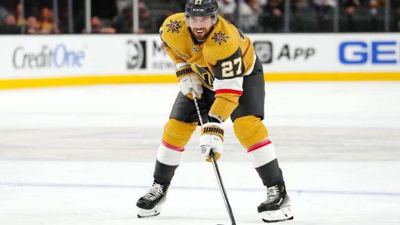 Oct 17, 2023; Las Vegas, Nevada, USA; Vegas Golden Knights defenseman Shea Theodore (27) prepares for a face off against the Dallas Stars during the third period at T-Mobile Arena. Mandatory Credit: Stephen R. Sylvanie-USA TODAY Sports