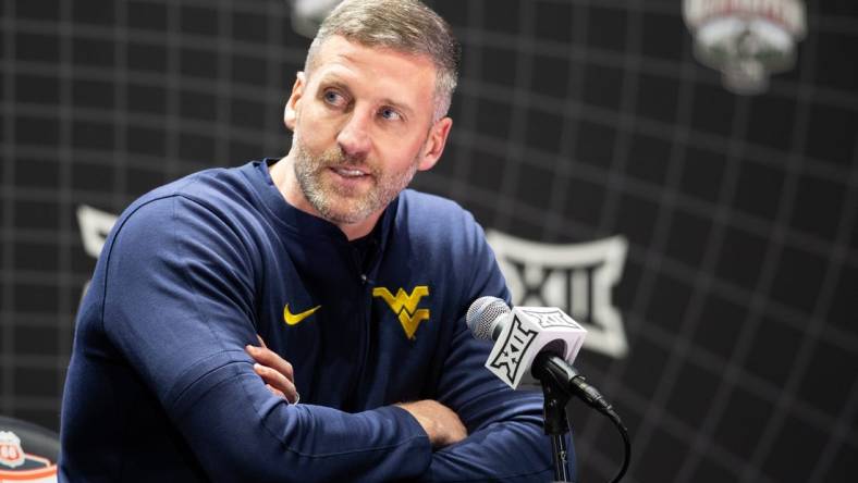 Oct 18, Kansas City, MO, USA; West Virginia interim head coach Josh Eilert answers questions at Big 12 Men s Basketball Tipoff at T-Mobile Center. Mandatory Credit: Kylie Graham-USA TODAY Sports