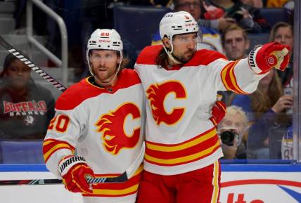 Oct 19, 2023; Buffalo, New York, USA;  Calgary Flames center Blake Coleman (20) celebrates his goal with defenseman Chris Tanev (8) during the third period against the Buffalo Sabres at KeyBank Center. Mandatory Credit: Timothy T. Ludwig-USA TODAY Sports