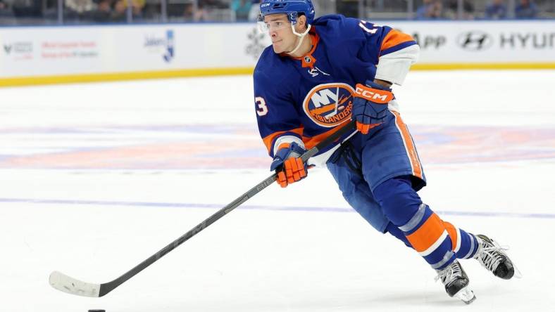 Oct 20, 2023; Elmont, New York, USA; New York Islanders center Mathew Barzal (13) skates with the puck against the New Jersey Devils during overtime at UBS Arena. Mandatory Credit: Brad Penner-USA TODAY Sports