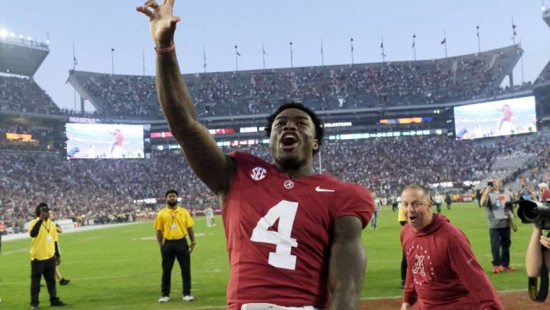 Oct 21, 2023; Tuscaloosa, Alabama, USA;  Alabama Crimson Tide quarterback Jalen Milroe (4) celebrates with fans after the Crimson Tide defeated Tennessee 34-20 at Bryant-Denny Stadium. Mandatory Credit: Gary Cosby Jr.-USA TODAY Sports