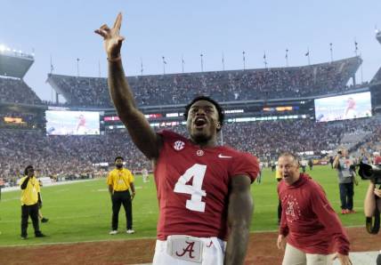 Oct 21, 2023; Tuscaloosa, Alabama, USA;  Alabama Crimson Tide quarterback Jalen Milroe (4) celebrates with fans after the Crimson Tide defeated Tennessee 34-20 at Bryant-Denny Stadium. Mandatory Credit: Gary Cosby Jr.-USA TODAY Sports