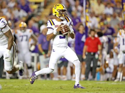 Oct 21, 2023; Baton Rouge, Louisiana, USA; LSU Tigers quarterback Jayden Daniels (5) looks to pass against the Army Black Knights during the first half at Tiger Stadium. Mandatory Credit: Danny Wild-USA TODAY Sports