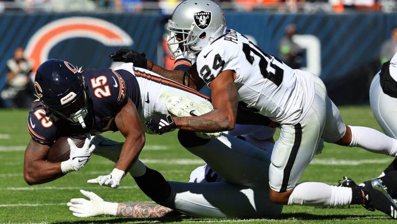 Oct 22, 2023; Chicago, Illinois, USA; Chicago Bears running back Darrynton Evans (25) rushes the ball against Las Vegas Raiders cornerback Marcus Peters (24) in the second half at Soldier Field. Mandatory Credit: Mike Dinovo-USA TODAY Sports