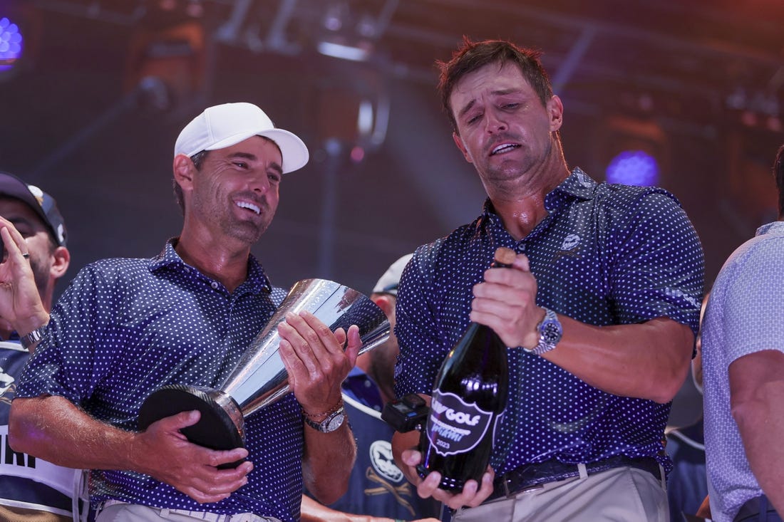 Oct 22, 2023; Doral, Florida, USA; Crushers GC team captain Bryson Dechambeau and Charles Howell III celebrate winning the team championship during the final round of the LIV Golf Miami golf tournament at Trump National Doral. Mandatory Credit: Sam Navarro-USA TODAY Sports