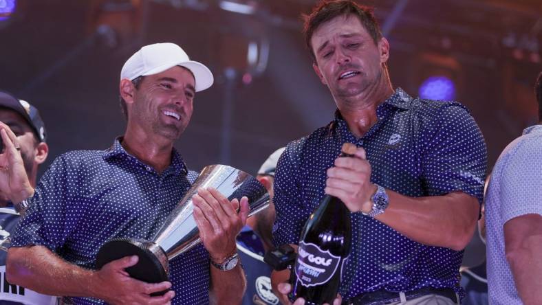 Oct 22, 2023; Doral, Florida, USA; Crushers GC team captain Bryson Dechambeau and Charles Howell III celebrate winning the team championship during the final round of the LIV Golf Miami golf tournament at Trump National Doral. Mandatory Credit: Sam Navarro-USA TODAY Sports