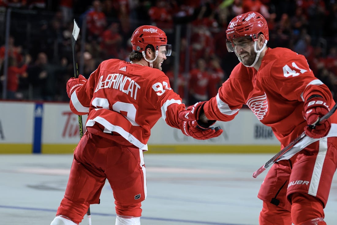 Oct 24, 2023; Detroit, Michigan, USA; Detroit Red Wings right wing Alex DeBrincat (93) celebrates with defenseman Shayne Gostisbehere (41)after scoring a power play goal against the Seattle Kraken in the third period at Little Caesars Arena. Mandatory Credit: Lon Horwedel-USA TODAY Sports