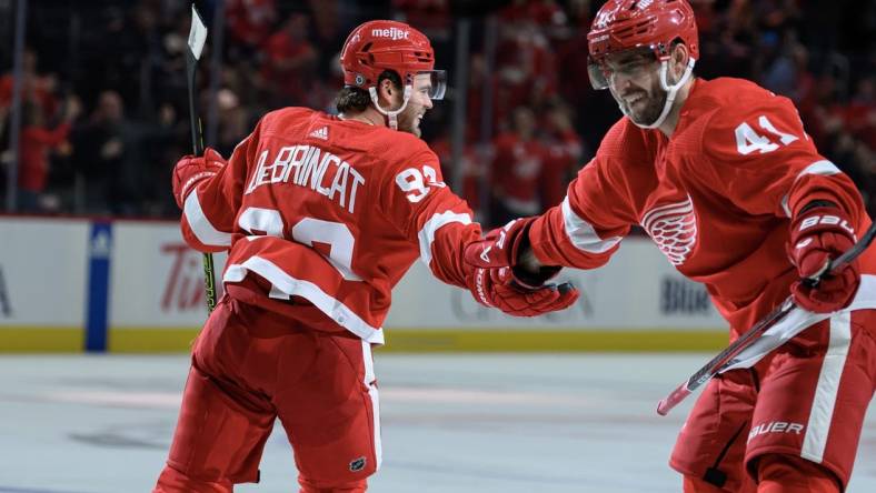 Oct 24, 2023; Detroit, Michigan, USA; Detroit Red Wings right wing Alex DeBrincat (93) celebrates with defenseman Shayne Gostisbehere (41)after scoring a power play goal against the Seattle Kraken in the third period at Little Caesars Arena. Mandatory Credit: Lon Horwedel-USA TODAY Sports