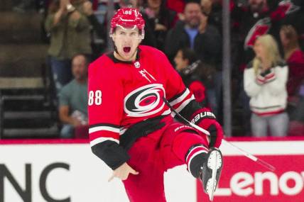 Oct 26, 2023; Raleigh, North Carolina, USA; Carolina Hurricanes center Martin Necas (88) celebrates his game winning goal in the overtime against the Seattle Kraken at PNC Arena. Mandatory Credit: James Guillory-USA TODAY Sports