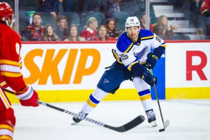 Oct 26, 2023; Calgary, Alberta, CAN; St. Louis Blues center Jordan Kyrou (25) controls the puck against the Calgary Flames during the third period at Scotiabank Saddledome. Mandatory Credit: Sergei Belski-USA TODAY Sports