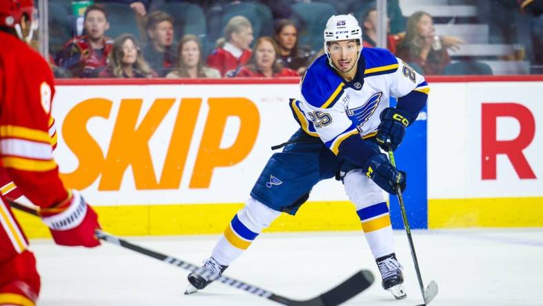 Oct 26, 2023; Calgary, Alberta, CAN; St. Louis Blues center Jordan Kyrou (25) controls the puck against the Calgary Flames during the third period at Scotiabank Saddledome. Mandatory Credit: Sergei Belski-USA TODAY Sports