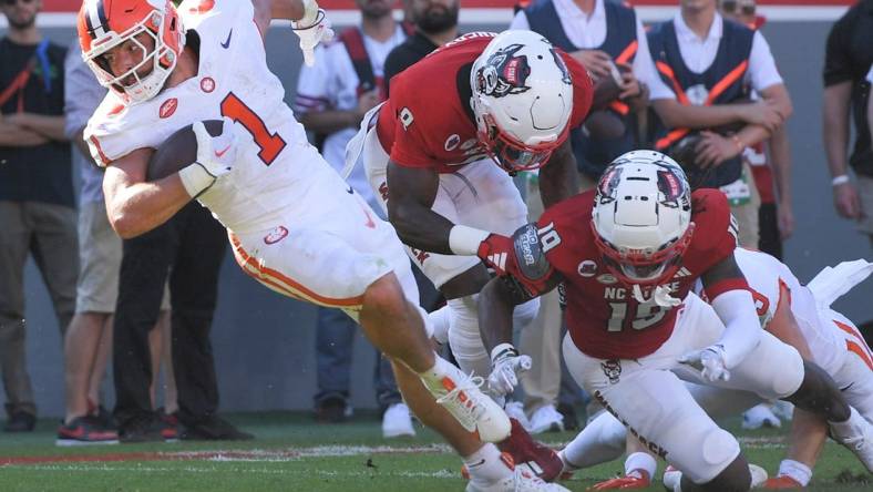 Oct 28, 2023; Raleigh, North Carolina, USA; Clemson Tigers running back Will Shipley (1) twists on a run before he is hit by North Carolina State Wolfpack cornerback Shyheim Battle (7) near the goal line during the second quarter at Carter-Finley Stadium. Mandatory Credit: Ken Ruinard-USA TODAY Sports