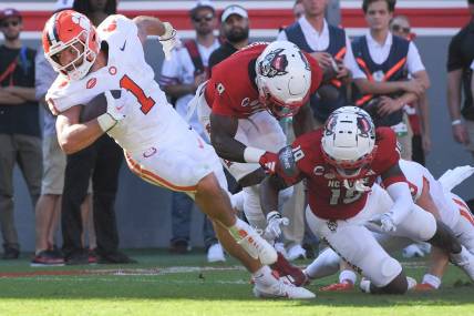 Oct 28, 2023; Raleigh, North Carolina, USA; Clemson Tigers running back Will Shipley (1) twists on a run before he is hit by North Carolina State Wolfpack cornerback Shyheim Battle (7) near the goal line during the second quarter at Carter-Finley Stadium. Mandatory Credit: Ken Ruinard-USA TODAY Sports