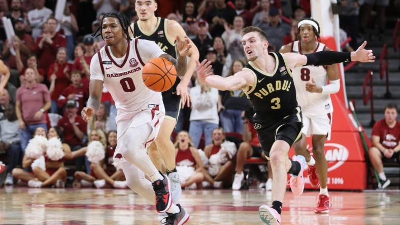 Oct 28, 2023; Fayetteville, AR, USA; Arkansas Razorbacks guard Khalif Battle (0) dribbles the ball against Purdue Boilermakers guard Braden Smith (3) on a fast break int he second half at Bud Walton Arena. Arkansas won 81-77. Mandatory Credit: Nelson Chenault-USA TODAY Sports