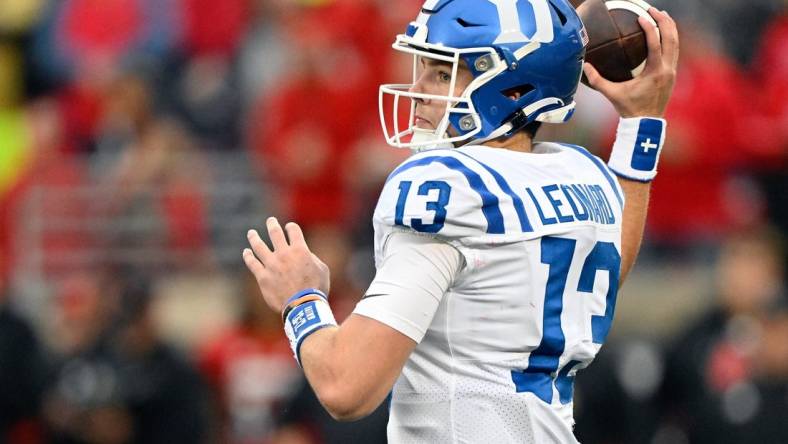 Oct 28, 2023; Louisville, Kentucky, USA;  Duke Blue Devils quarterback Riley Leonard (13) looks to pass the ball against the Louisville Cardinals during the second half at L&N Federal Credit Union Stadium. Mandatory Credit: Jamie Rhodes-USA TODAY Sports