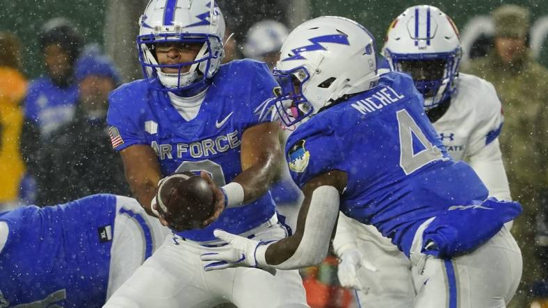 Oct 28, 2023; Fort Collins, Colorado, USA;  Air Force Falcons quarterback Zac Larrier (9) hands off to Air Force Falcons fullback Emmanuel Michel (4) at Sonny Lubick Field at Canvas Stadium. Mandatory Credit: Michael Madrid-USA TODAY Sports