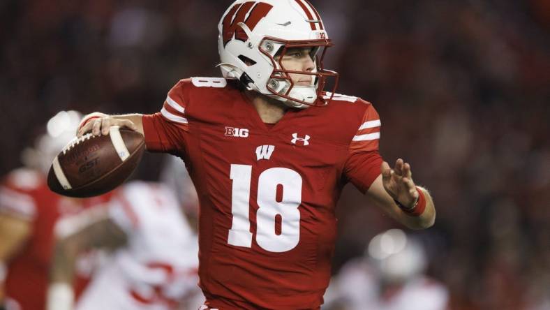 Oct 28, 2023; Madison, Wisconsin, USA;  Wisconsin Badgers quarterback Braedyn Locke (18) throws a pass during the fourth quarter against the Ohio State Buckeyes at Camp Randall Stadium. Mandatory Credit: Jeff Hanisch-USA TODAY Sports