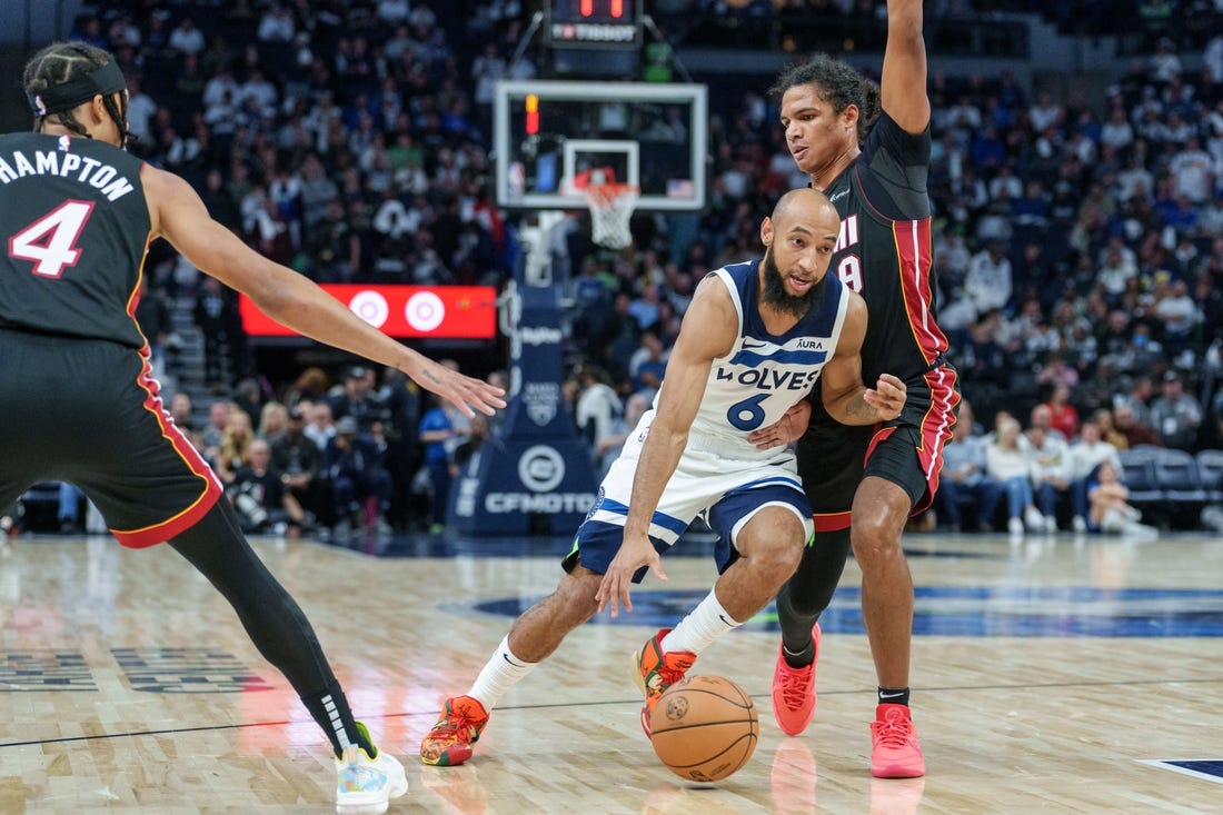 Oct 28, 2023; Minneapolis, Minnesota, USA; Minnesota Timberwolves guard Jordan McLaughlin (6) dribbles by Miami Heat guard Dru Smith (9) in the fourth quarter at Target Center. Mandatory Credit: Matt Blewett-USA TODAY Sports