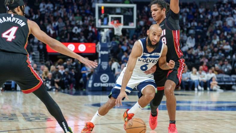 Oct 28, 2023; Minneapolis, Minnesota, USA; Minnesota Timberwolves guard Jordan McLaughlin (6) dribbles by Miami Heat guard Dru Smith (9) in the fourth quarter at Target Center. Mandatory Credit: Matt Blewett-USA TODAY Sports