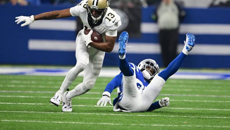 Oct 29, 2023; Indianapolis, Indiana, USA; New Orleans Saints wide receiver Michael Thomas (13) evades a tackle by Indianapolis Colts cornerback Tony Brown (38) during the first quarter at Lucas Oil Stadium. Mandatory Credit: Marc Lebryk-USA TODAY Sports