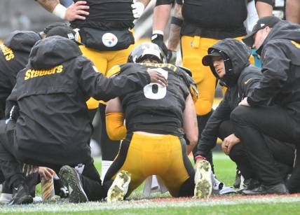 Oct 29, 2023; Pittsburgh, Pennsylvania, USA;  Pittsburgh Steelers quarterback Kenny Pickett (8) is tended to after taking a hit against the Jacksonville Jaguars during the second quarter at Acrisure Stadium. Mandatory Credit: Philip G. Pavely-USA TODAY Sports