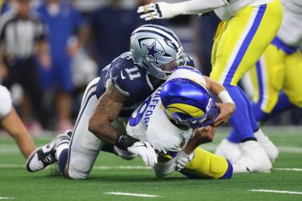 Oct 29, 2023; Arlington, Texas, USA; Los Angeles Rams quarterback Matthew Stafford (9) is sacked by Dallas Cowboys linebacker Micah Parsons (11) in the second quarter at AT&T Stadium. Mandatory Credit: Tim Heitman-USA TODAY Sports