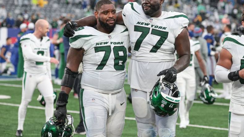 Oct 29, 2023; East Rutherford, New Jersey, USA; New York Jets guard Laken Tomlinson (78) and offensive tackle Mekhi Becton (77) walk off the field after defeating the New York Giants in overtime at MetLife Stadium. Mandatory Credit: Vincent Carchietta-USA TODAY Sports