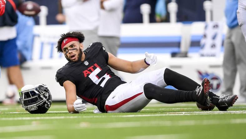 Oct 29, 2023; Nashville, Tennessee, USA;  Atlanta Falcons wide receiver Drake London (5) lays on the field after taking a hit from Tennessee Titans linebacker Jack Gibbens (50) during the second half at Nissan Stadium. Mandatory Credit: Steve Roberts-USA TODAY Sports