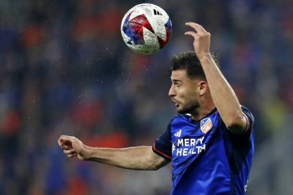 Oct 29, 2023; Cincinnati, OH, USA; FC Cincinnati defender Matt Miazga (21) heads the ball against the New York Red Bulls during the first half of game one in a round one match of the 2023 MLS Cup Playoffs at TQL Stadium. Mandatory Credit: Katie Stratman-USA TODAY Sports