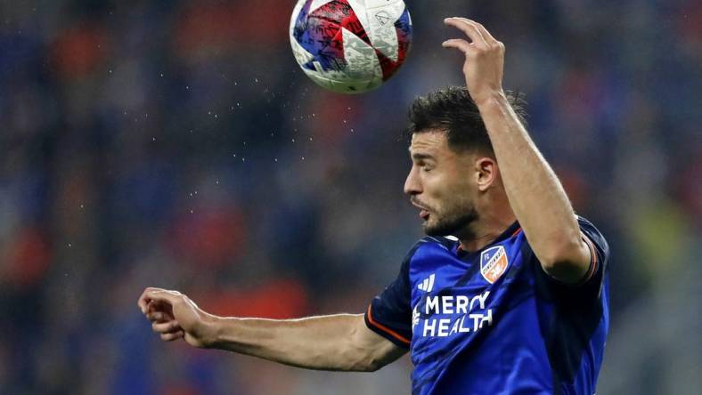 Oct 29, 2023; Cincinnati, OH, USA; FC Cincinnati defender Matt Miazga (21) heads the ball against the New York Red Bulls during the first half of game one in a round one match of the 2023 MLS Cup Playoffs at TQL Stadium. Mandatory Credit: Katie Stratman-USA TODAY Sports