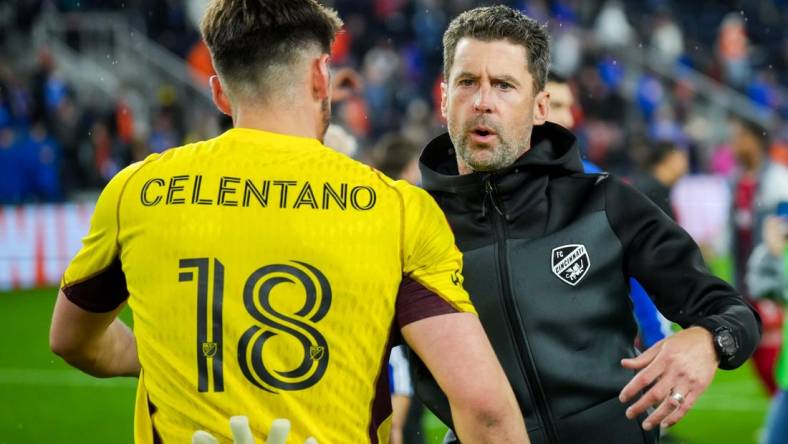 Oct 29, 2023; Cincinnati, OH, USA; FC Cincinnati head coach Pat Noonan hugs goalkeeper Roman Celentano (18) on the field after his team defeats the New York Red Bulls in game one in a round one match of the 2023 MLS Cup Playoffs at TQL Stadium. Mandatory Credit: Aaron Doster-USA TODAY Sports